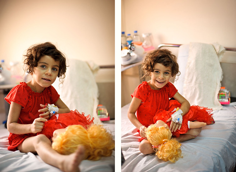 Deeya sits on her hospital bed in a red nightgown. Her lifesaving heart surgery made everything possible, even school.