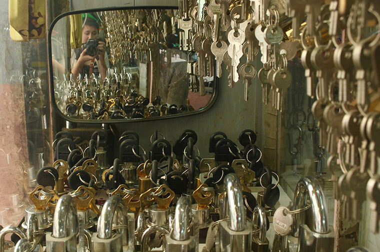A self portrait of Janet captured in a small mirror, amongst many keys, at a stall in the bazaar.