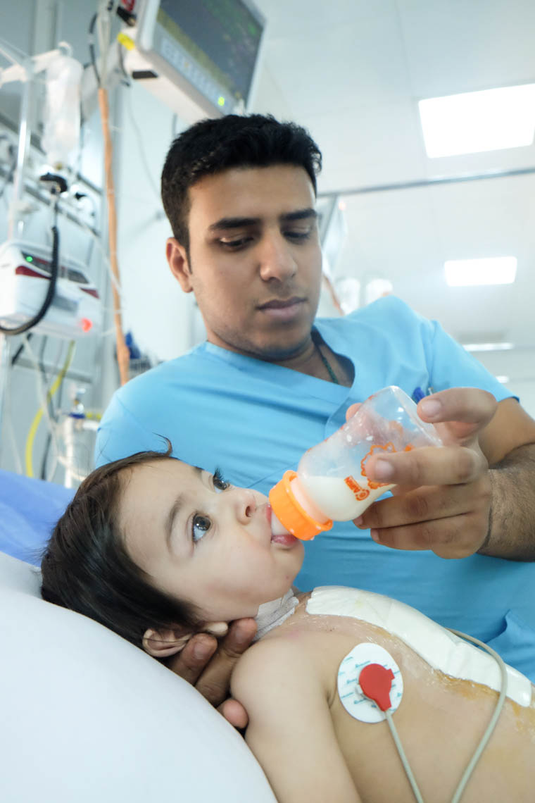 Baby Adam being fed by Ali, an ICU nurse