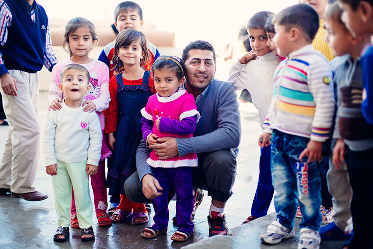 A Kurdish volunteer spends time with IDP children displaced by the war with ISIS.