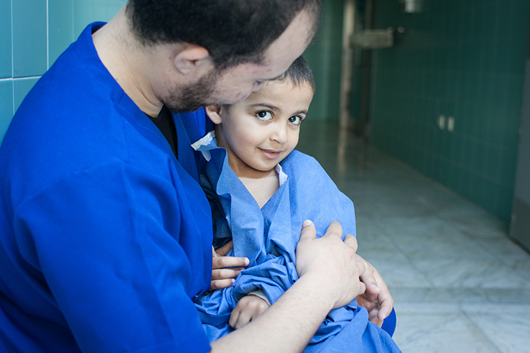 Hamam waits outside of the operating room, ready for his heart surgery.