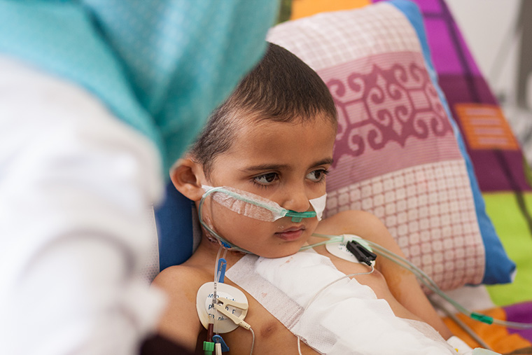 While Hamam's mom gets a little rest, a friend sits with her son after heart surgery.