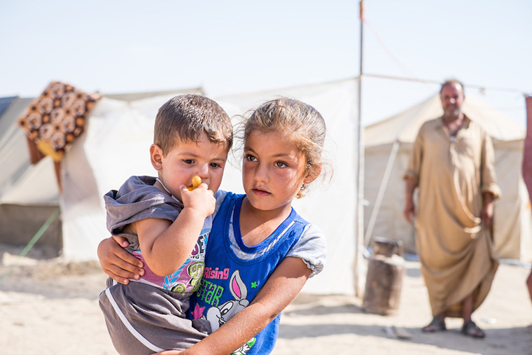Displaced kids do their best to deal with the heat as we deliver relief aid to their families. They are camped in the dessert, 3 miles from the front line with ISIS.