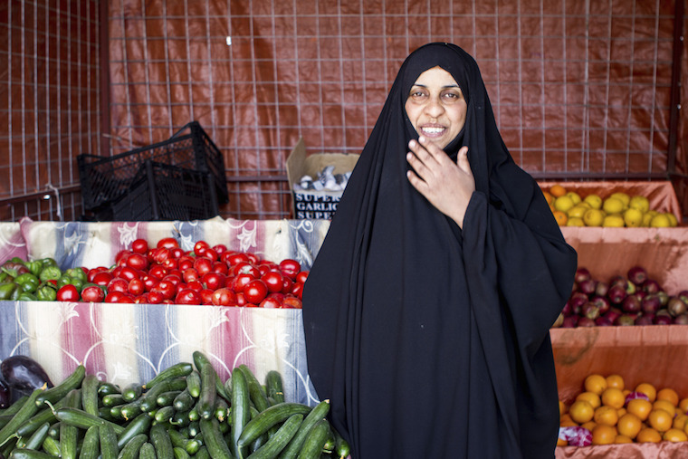 A photo of Madeeha at her vegetable shop in Baghdad