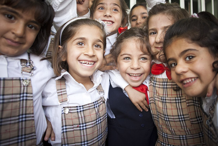 Deeya and her friends at school, beaming smiles, being kids—just as it should be.