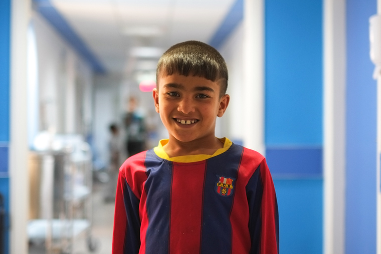 Young Mohammad, still waiting for lifesaving heart surgery, stands in the hallway of the new heart center in Nasiriyah, Iraq.