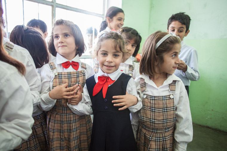 Deeya and her friends, dressed in their school uniforms, hold hand and smile. None of this would be possible without Deeya's lifesaving heart surgery.