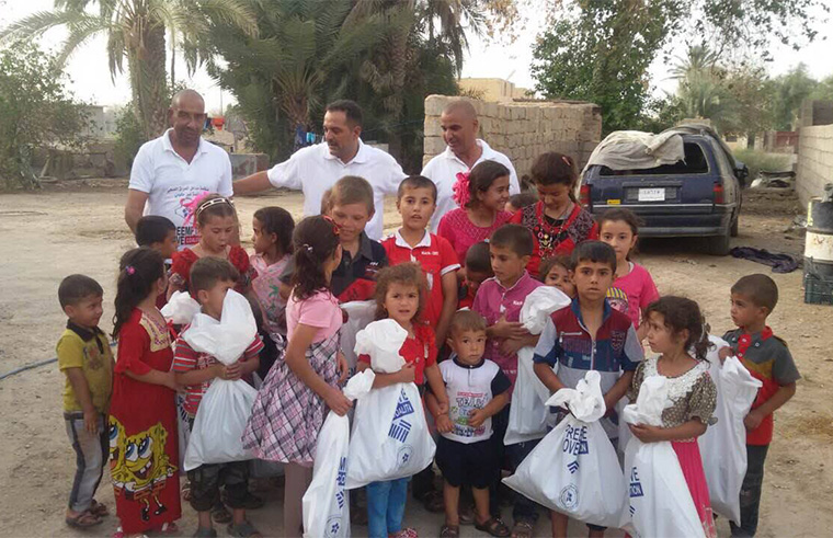 The local volunteer team gathers the children from a couple neighbouring houses and gives them gifts for Eid al Adha.
