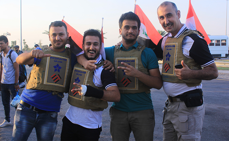 Staff from Preemptive Love Coalition and our partners Iraq Health Aid Organization pose wearing flak jackets, before departing for an emergency food drop in the besieged city of Haditha, Iraq.