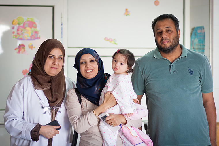 Little Malak, her cardiologist, and parents stop for a photo as Malak is discharged from hospital.