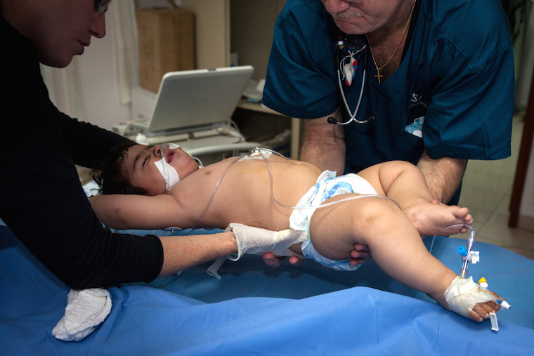 A young boy is moved during a procedure to examine his heart.