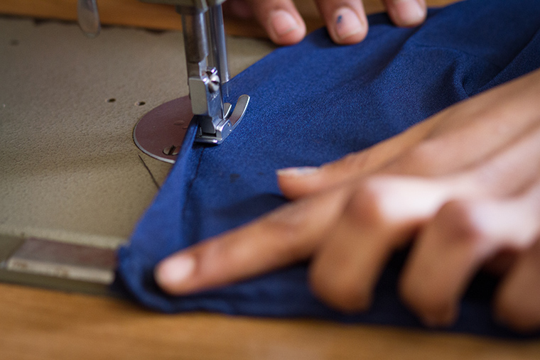 Sewing up the side seams of a new dress.