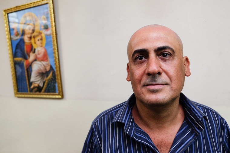 a portrait of Isaac, an Iraqi Christian man from Baghdad