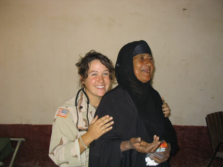 Diana Oestreich was part of the US forces in Iraq during the US invasion. In this photo she stands with a local Iraqi woman. Diana helped her receive medical care.
