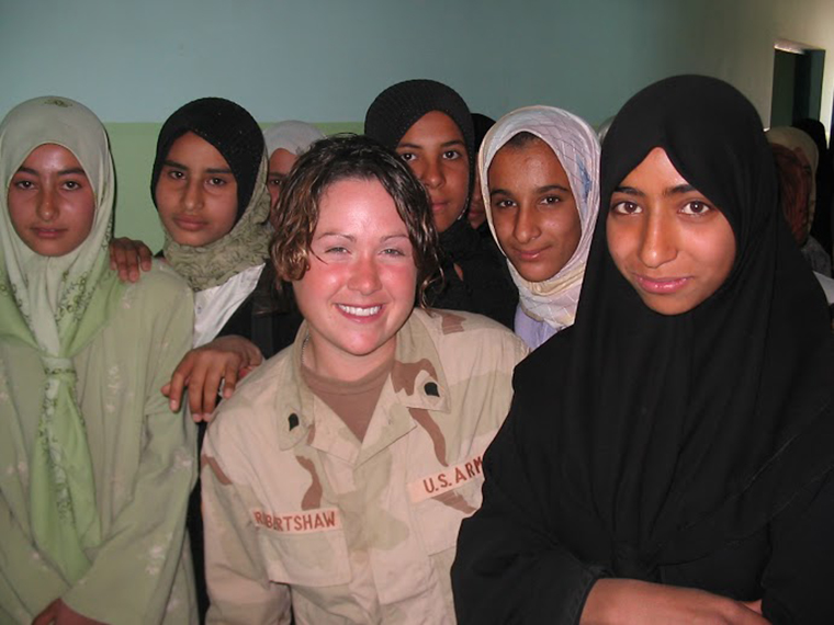 Diana Oestreich was part of the US forces in Iraq during the US invasion. In this photo she stands with a group of local Iraqi women.