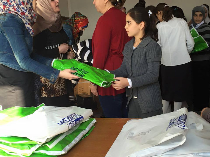 Teachers hand out supplies to students at the school for displaced girls in northern Iraq.