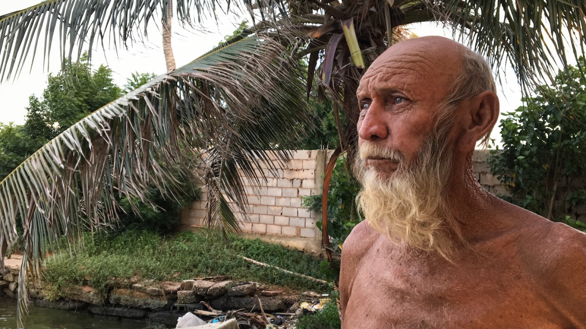 Man surveys damage to his property after a storm in Venezuela.