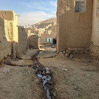 An alley between mud-brick buildings in Afghanistan.