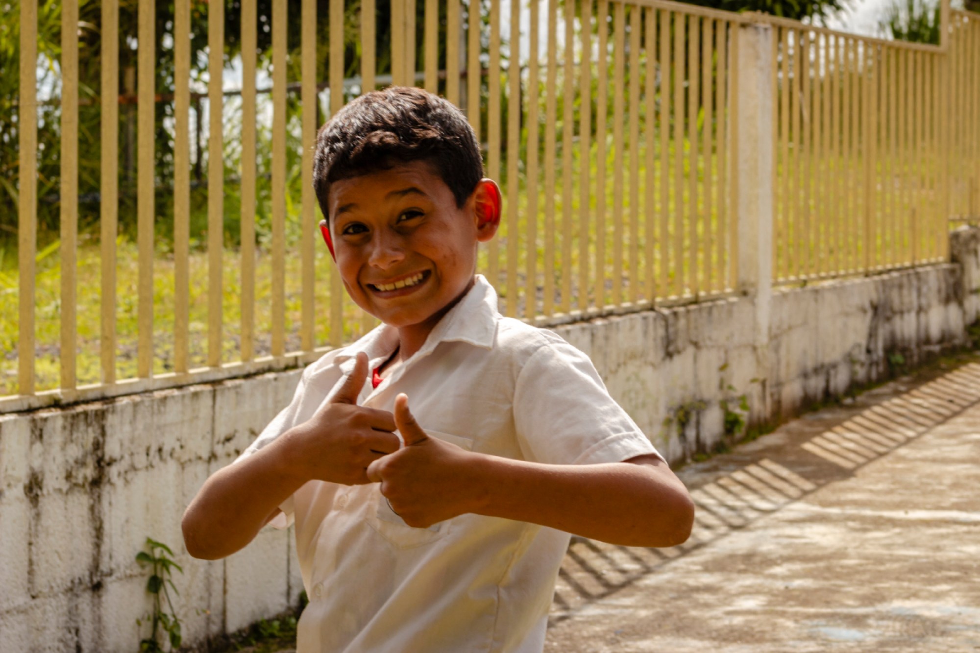 Andres flashes a double thumbs up at school. Photo by Angelika Ramirez